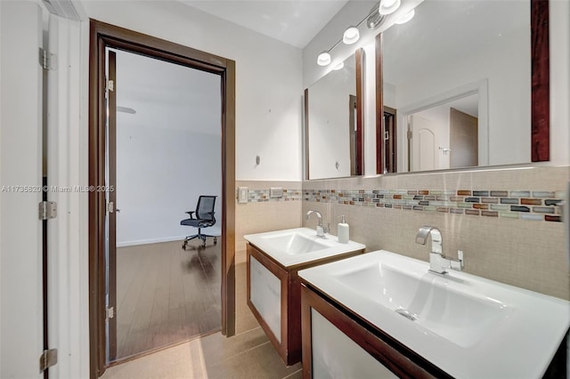 bathroom featuring tile walls, vanity, and wood-type flooring