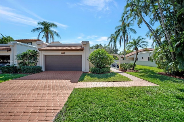 view of front facade with a garage and a front yard