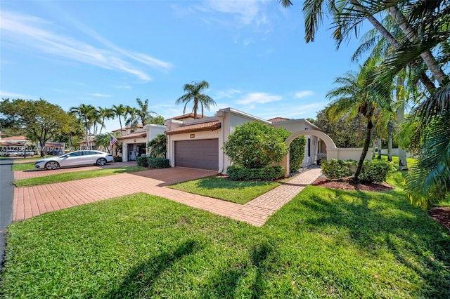 view of front of property with a garage and a front yard