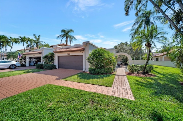 view of front of house with a garage and a front yard