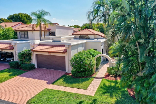 mediterranean / spanish-style house with a garage