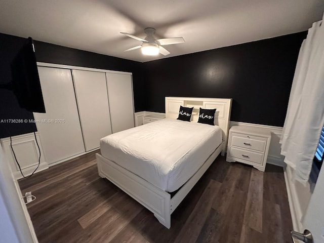 bedroom featuring dark wood-type flooring, ceiling fan, and a closet