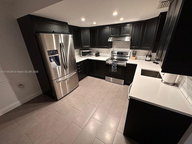 kitchen featuring tasteful backsplash and appliances with stainless steel finishes