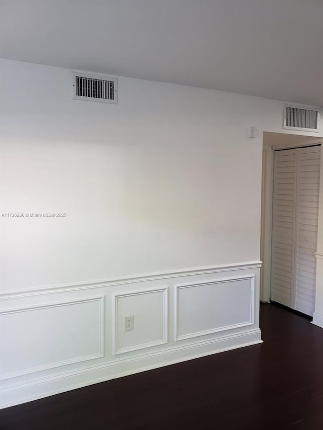 corridor with dark hardwood / wood-style flooring