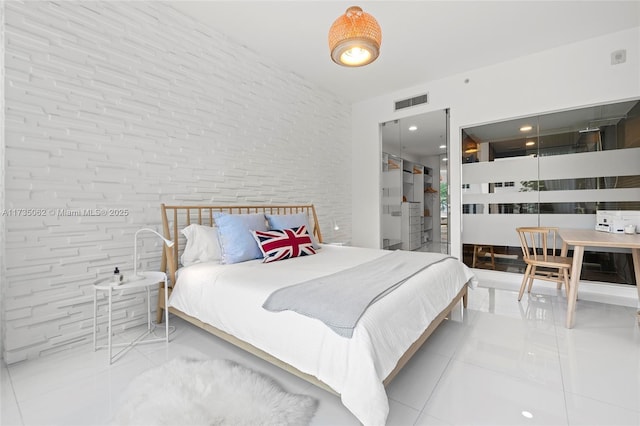 tiled bedroom with brick wall