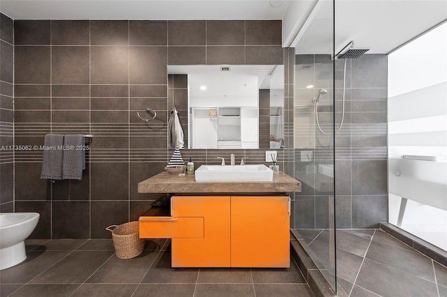 bathroom featuring tiled shower, tile patterned floors, tile walls, a bidet, and vanity