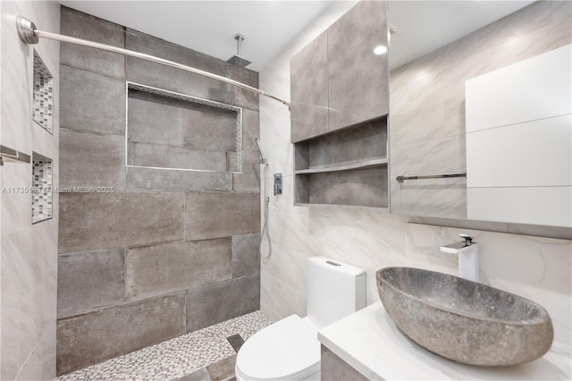 1498 NE 39th St, Oakland Park, FL 33334 - bathroom featuring tile walls, a tile shower, toilet, and vanity