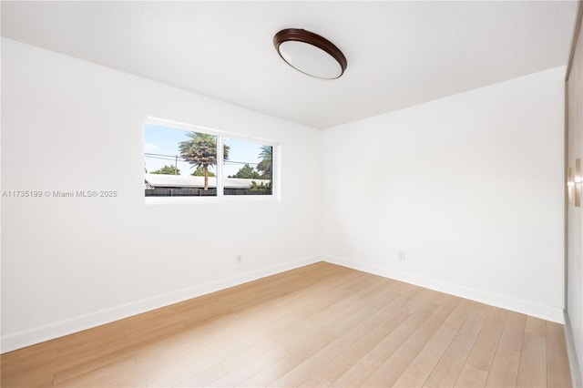 1498 NE 39th St, Oakland Park, FL 33334 - empty room with baseboards and light wood finished floors