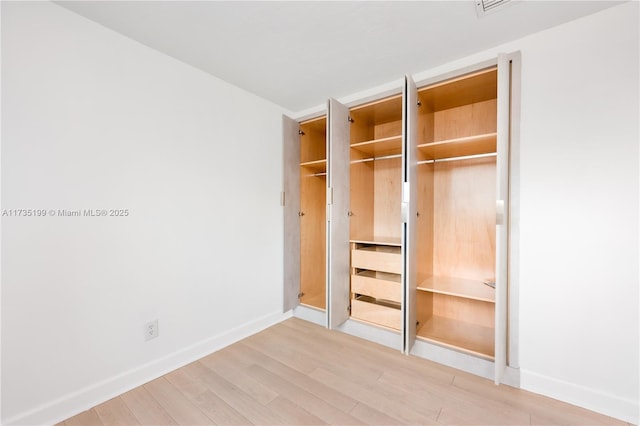 1498 NE 39th St, Oakland Park, FL 33334 - unfurnished bedroom with light wood-type flooring and baseboards