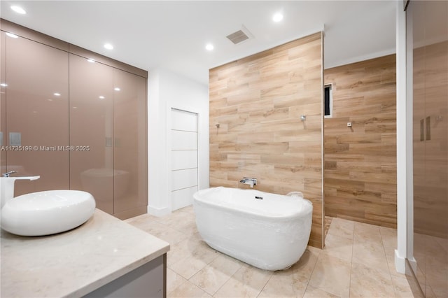 1498 NE 39th St, Oakland Park, FL 33334 - full bathroom with tiled shower, a soaking tub, vanity, and recessed lighting