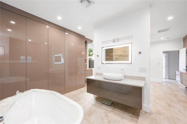 1498 NE 39th St, Oakland Park, FL 33334 - bathroom featuring tile patterned floors, recessed lighting, and vanity