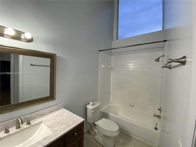 full bathroom featuring vanity, tile patterned flooring, toilet, and tiled shower / bath