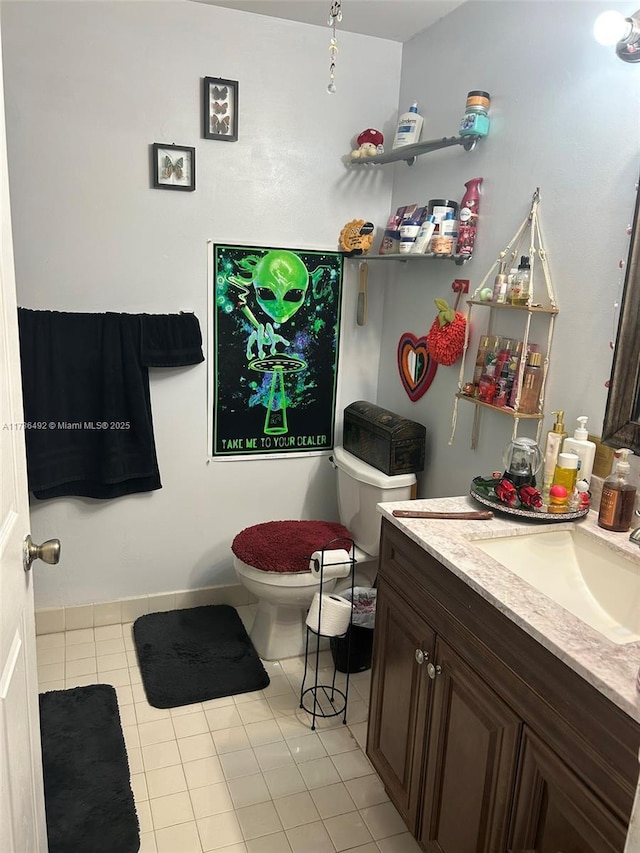 bathroom featuring vanity, tile patterned floors, and toilet