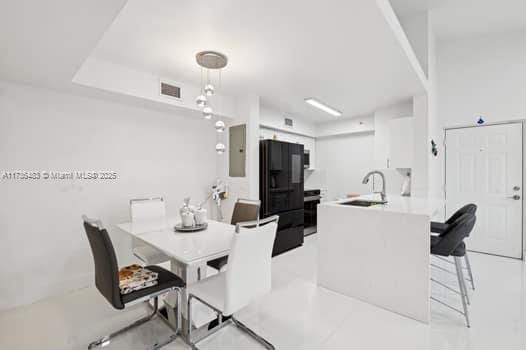 dining room featuring sink and electric panel