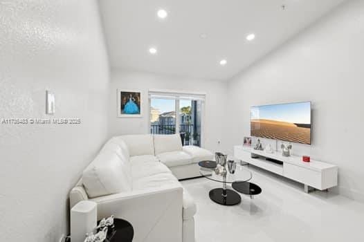 living room featuring lofted ceiling