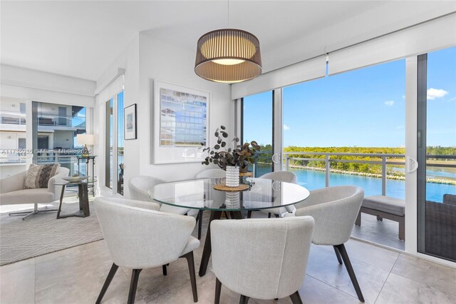 tiled dining space featuring a water view