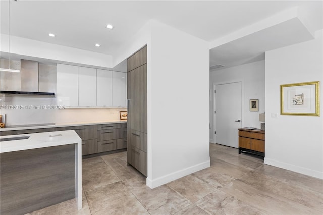 kitchen featuring wall chimney range hood