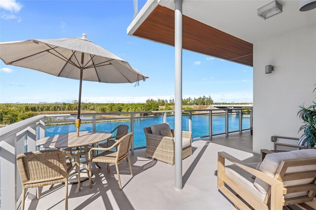 view of patio / terrace with a balcony and a water view