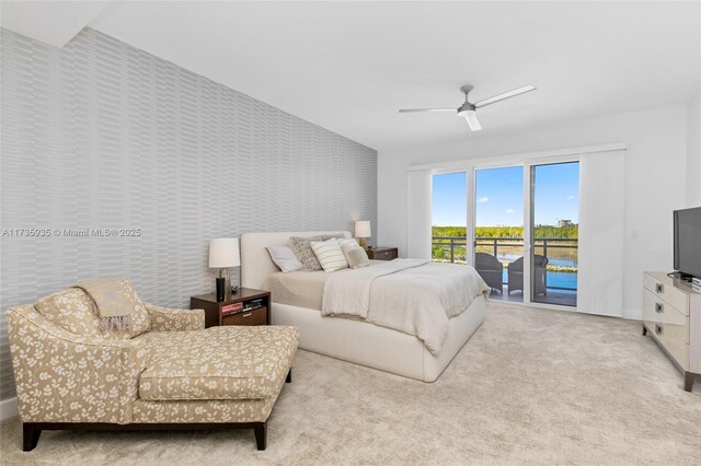 bedroom featuring light colored carpet, access to exterior, and ceiling fan