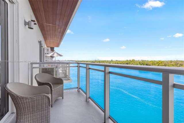 view of pool with a water view and a patio