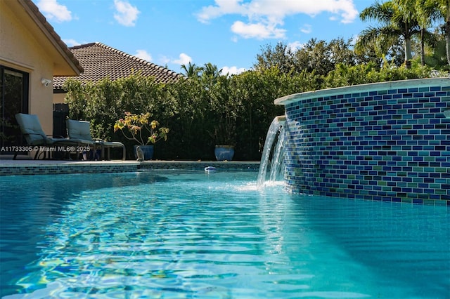 view of pool with pool water feature