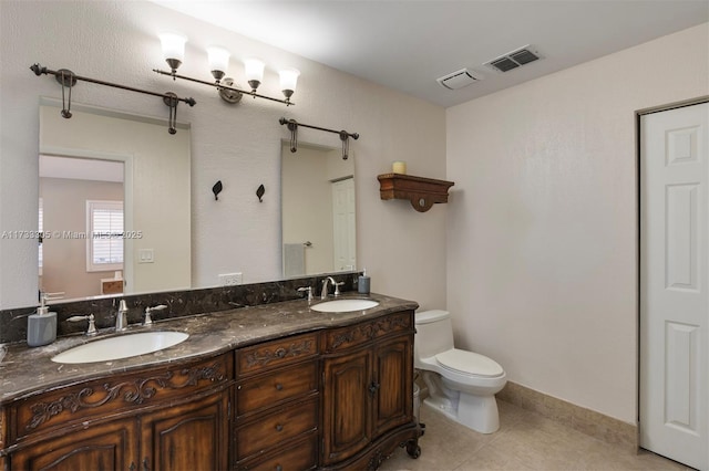 bathroom with vanity, tile patterned flooring, and toilet