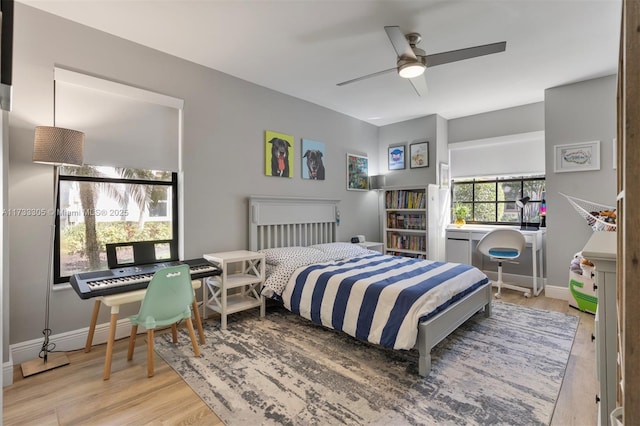 bedroom with ceiling fan and light hardwood / wood-style flooring