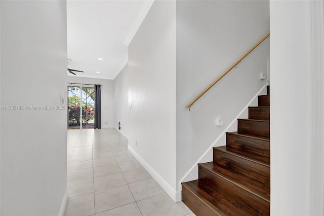 hallway with light tile patterned flooring and ornamental molding