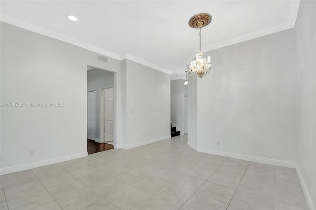 spare room with crown molding and a chandelier