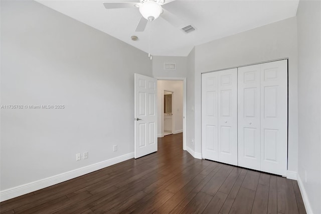 unfurnished bedroom featuring a closet, dark hardwood / wood-style floors, and ceiling fan