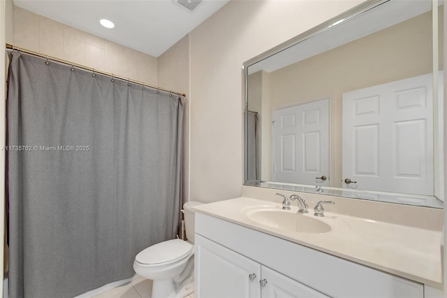 bathroom featuring vanity, tile patterned flooring, and toilet