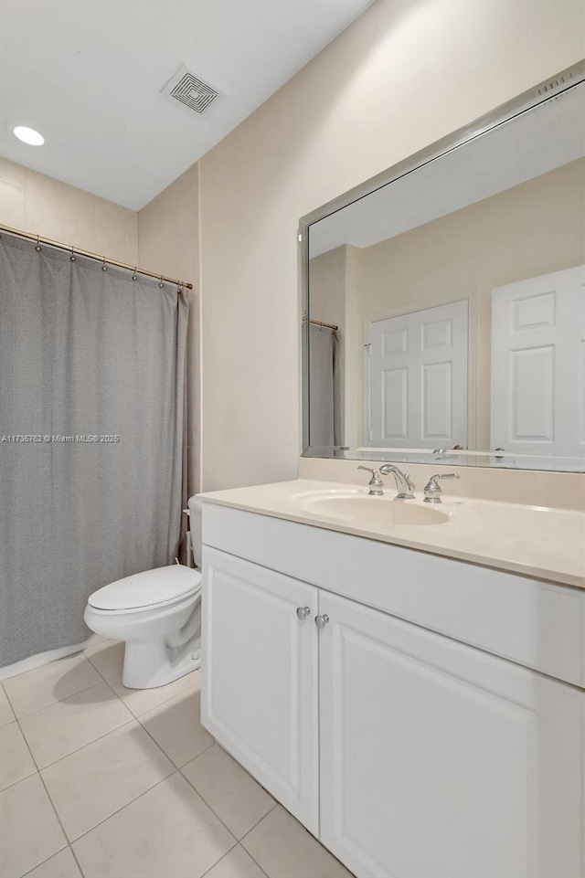 bathroom with vanity, tile patterned floors, and toilet