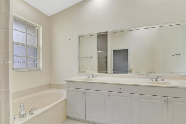 bathroom featuring tile patterned flooring, vanity, and plus walk in shower