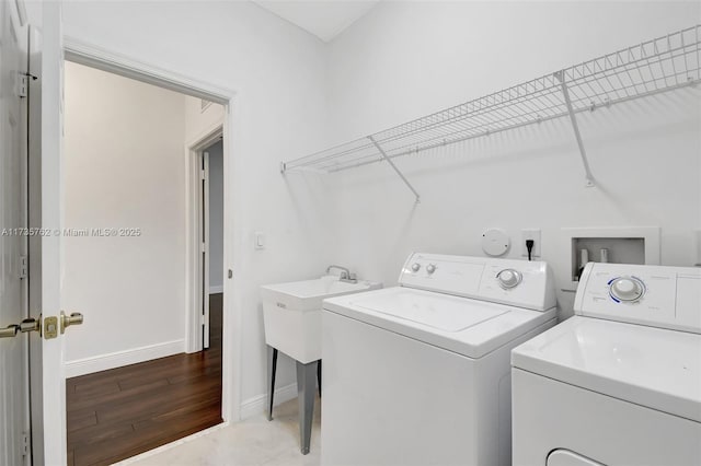 laundry area featuring hardwood / wood-style flooring and washing machine and dryer