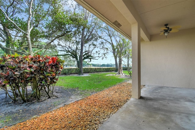 view of yard with a patio and ceiling fan