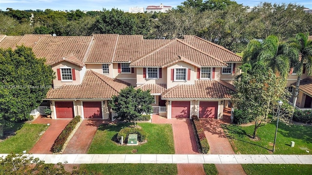 mediterranean / spanish-style home with a front lawn