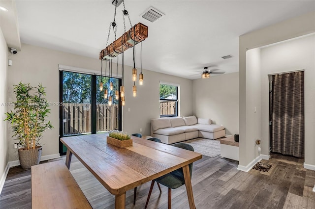 dining space with ceiling fan and dark hardwood / wood-style flooring