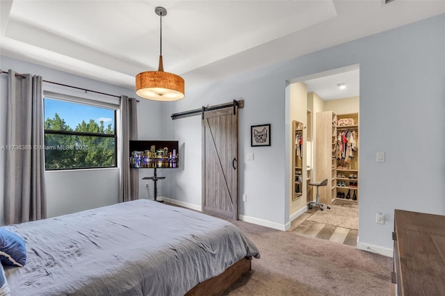 18330 NW 91st Ct Unit 18330, Hialeah, FL 33018 - carpeted bedroom with a barn door, baseboards, and a tray ceiling
