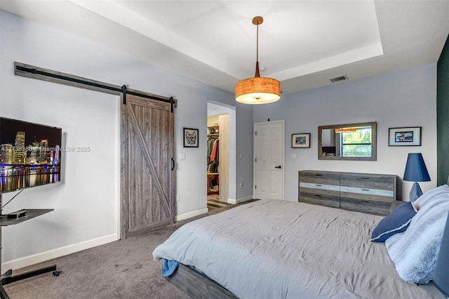 18330 NW 91st Ct Unit 18330, Hialeah, FL 33018 - bedroom featuring a barn door, baseboards, a spacious closet, and carpet floors