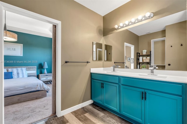 18330 NW 91st Ct Unit 18330, Hialeah, FL 33018 - bathroom with wood finished floors, ensuite bath, double vanity, and baseboards