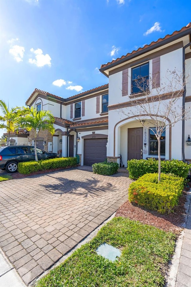 18330 NW 91st Ct Unit 18330, Hialeah, FL 33018 - townhome / multi-family property featuring decorative driveway, stucco siding, and a tiled roof