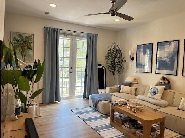 living room with ceiling fan and light wood-type flooring