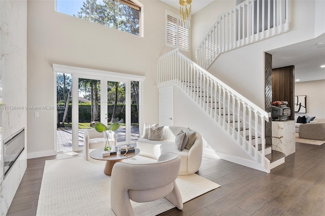 living room with french doors, a towering ceiling, and dark hardwood / wood-style flooring