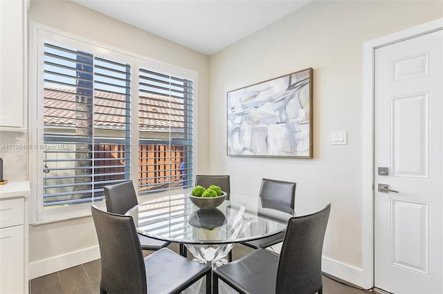 dining room with dark hardwood / wood-style flooring