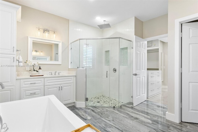 bathroom featuring hardwood / wood-style flooring, vanity, and an enclosed shower