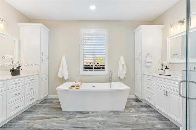 bathroom featuring hardwood / wood-style flooring, vanity, and plus walk in shower