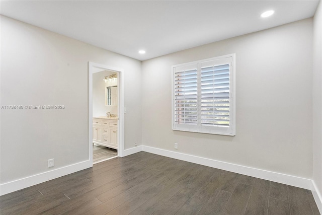 unfurnished bedroom featuring dark wood-type flooring and sink