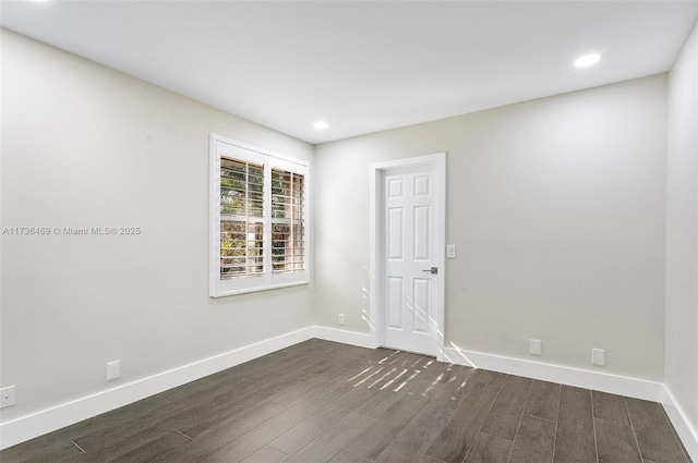 spare room featuring dark wood-type flooring