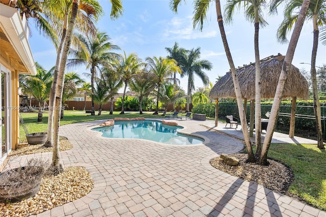 view of pool featuring a yard and a patio area