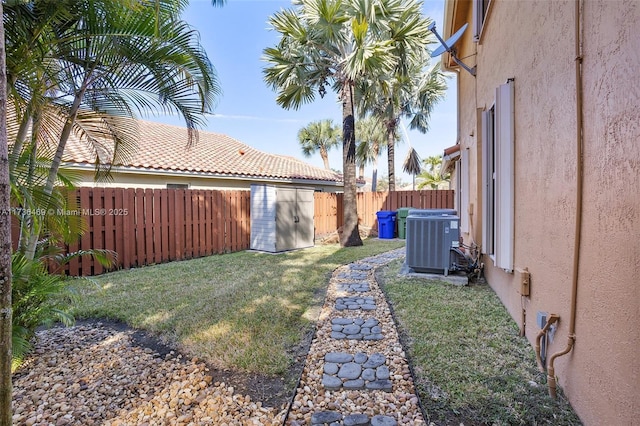 view of yard with cooling unit and a storage shed